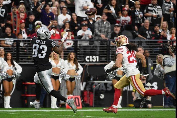 Las Vegas Raiders tight end Darren Waller (83) catches a 24-yard touchdown pass while being defended by San Francisco 49ers safety Talanoa Hufanga (29) during the first half of an NFL football game between the San Francisco 49ers and Las Vegas Raiders, Sunday, Jan. 1, 2023, in Las Vegas. (AP Photo/David Becker)