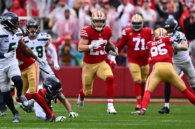 San Francisco 49ers' Christian McCaffrey (23) runs for yardage against the Seattle Seahawks in the first quarter of their NFC wild-card playoff game at Levi's Stadium in Santa Clara, Calif., on Saturday, Jan. 14, 2023. (Jose Carlos Fajardo/Bay Area News Group)