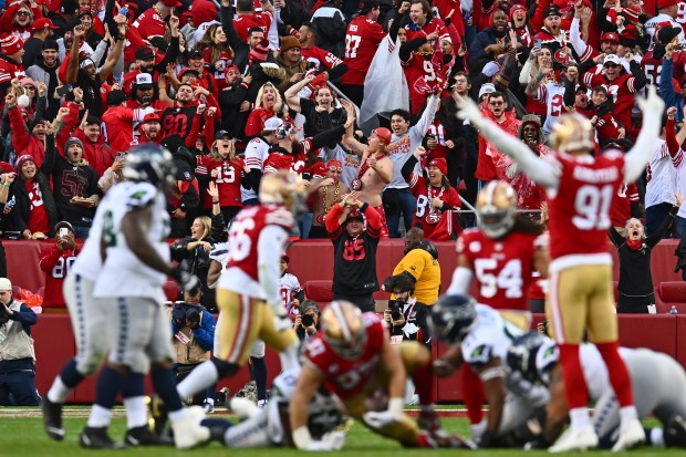 San Francisco 49ers fans celebrate after Nick Bosa (97) recovers a fumble by Seattle Seahawks quarterback Geno Smith (7) in the third quarter of their NFC wild-card playoff game at Levi's Stadium in Santa Clara, Calif., on Saturday, Jan. 14, 2023. The San Francisco 49ers defeated the Seattle Seahawks 41-23. (Jose Carlos Fajardo/Bay Area News Group)