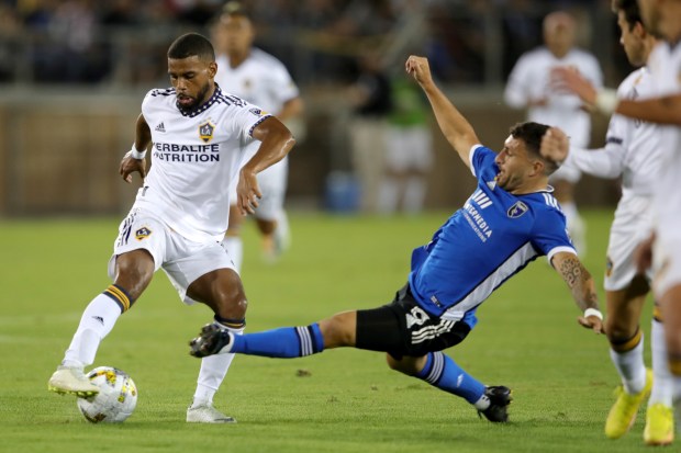 STANFORD, CALIFORNIA - SEPTEMBER 24: San Jose Earthquakes' Eric Remedi (5) slides to steal the ball against LA Galaxy's Chase Gasper (77) in the second half of their MLS California Clasico soccer match at Stanford Stadium in Stanford, Calif., on Saturday, Sept. 24, 2022. (Ray Chavez/Bay Area News Group)