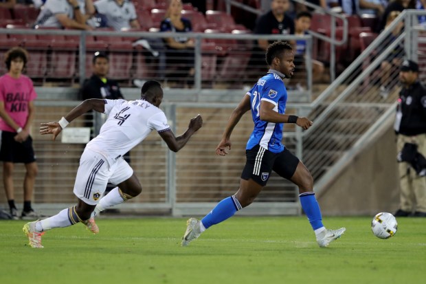 STANFORD, CALIFORNIA - SEPTEMBER 24: San Jose Earthquakes' Jeremy Ebobisse (11) dribbles past LA Galaxy's Séga Coulibaly (4) in the first half of their MLS California Clasico at Stanford Stadium in Stanford, Calif., on Saturday, Sept. 24, 2022. (Ray Chavez/Bay Area News Group)