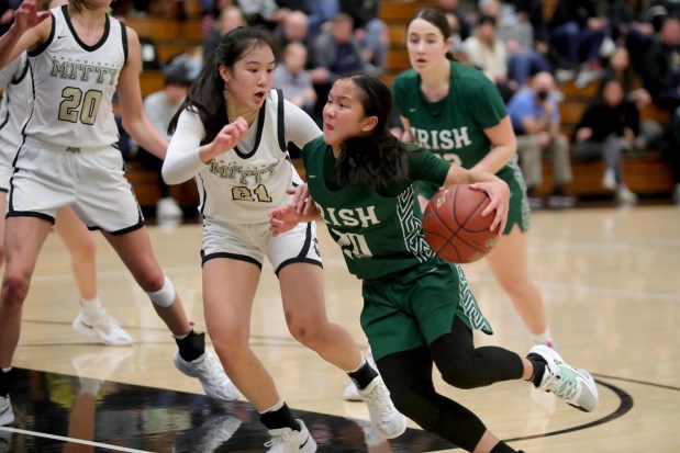 Sacred Heart Cathedral's Reza Poe (20) drives to to the hoop against Archbishop Mitty's April Chan (21) during a West Catholic Athletic League basketball game at Archbishop Mitty High in San Jose, Calif., on Wednesday, Jan. 11, 2023. (Ray Chavez/Bay Area News Group)