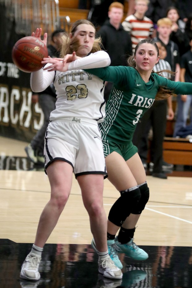 Archbishop Mitty's Elle Hanson (23) and Sacred Heart Cathedral's Leilani Blecha (3) fought for a rebound during a West Catholic Athletic League basketball game at Archbishop Mitty High in San Jose, Calif., on Wednesday, Jan. 11, 2023. (Ray Chavez/Bay Area News Group)