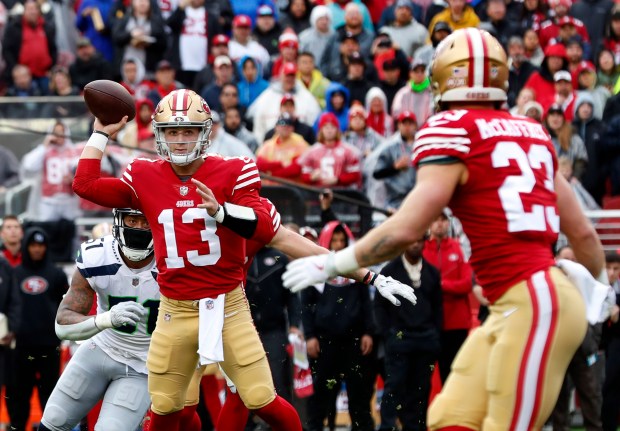 San Francisco 49ers quarterback Brock Purdy (13) connects with Christian McCaffrey (23) on a 3-yard touchdown pass in the first quarter of the NFC wild-card playoff game, Saturday, Jan. 14, 2023, at Levi's Stadium in Santa Clara, Calif. (Karl Mondon/Bay Area News Group)