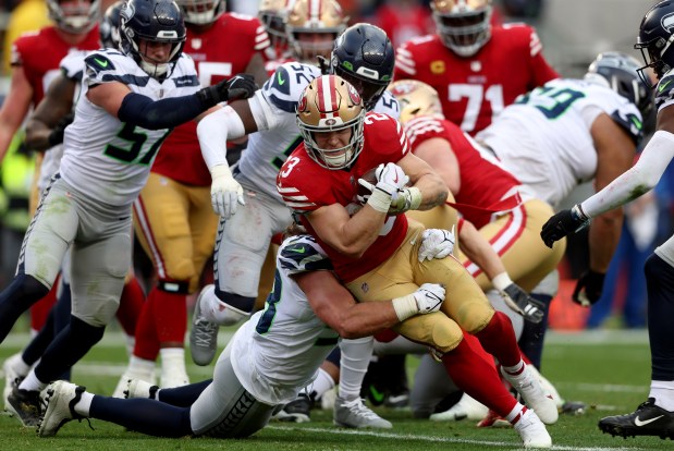 San Francisco 49ers' Christian McCaffrey (23) rushes during an opening touchdown drive in the third quarter of their NFC wild-card playoff game against the Seattle Seahawks, Saturday, Jan. 14, 2023, at Levi's Stadium in Santa Clara, Calif. (Karl Mondon/Bay Area News Group)