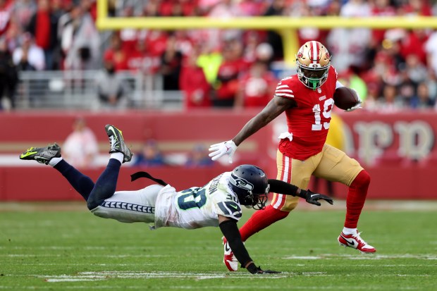San Francisco 49ers' Deebo Samuel (19) eludes a diving Seattle Seahawks' Michael Jackson (30) in the second quarter of their NFC wild-card playoff game, Saturday, Jan. 14, 2023, at Levi's Stadium in Santa Clara, Calif. (Karl Mondon/Bay Area News Group)