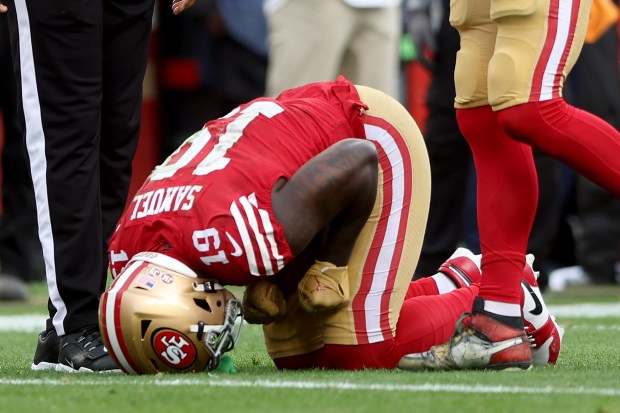San Francisco 49ers' Deebo Samuel (19) bends over in pain after having his ankle yanked by Seattle Seahawk's Jonathan Abram in the second half of their NFC wild-card playoff game, Saturday, Jan. 14, 2023, at Levi's Stadium in Santa Clara, Calif. (Karl Mondon/Bay Area News Group)