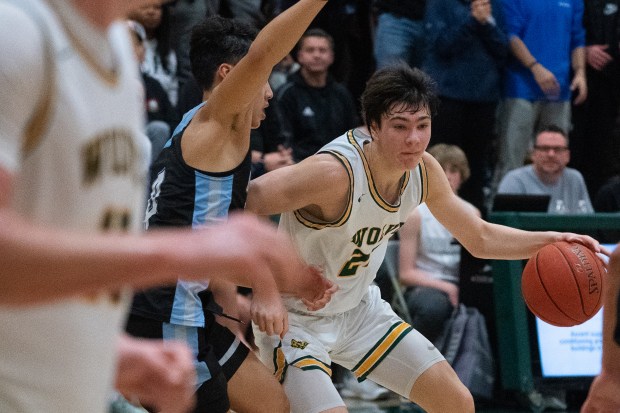 San Ramon Valley Wolves guard Luke Isaak, right, drives against the visiting Dougherty Valley Wildcats in the second half at San Ramon Valley High School in San Ramon, CA on Tuesday, January 10, 2023. Dougherty Valley takes the win over San Ramon 64-58. (Don Feria for Bay Area News Group)