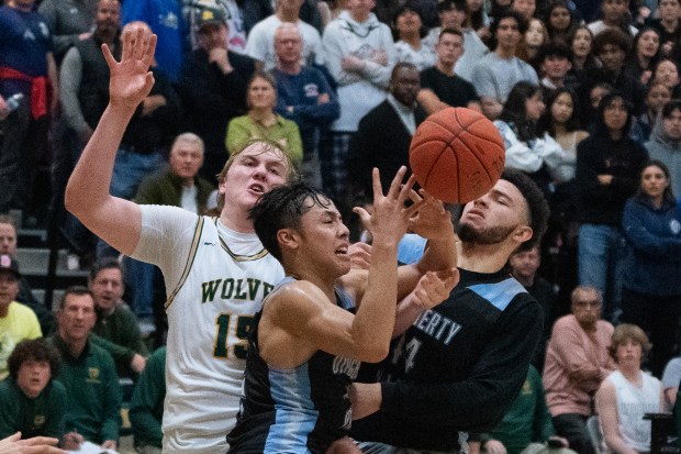 Connor Sevilla, center, of the visiting Dougherty Valley Wildcats looks for possession in the middle of traffic at San Ramon Valley High School in San Ramon, CA on Tuesday, January 10, 2023.Dougherty Valley takes the win over San Ramon 64-58. (Don Feria for Bay Area News Group)