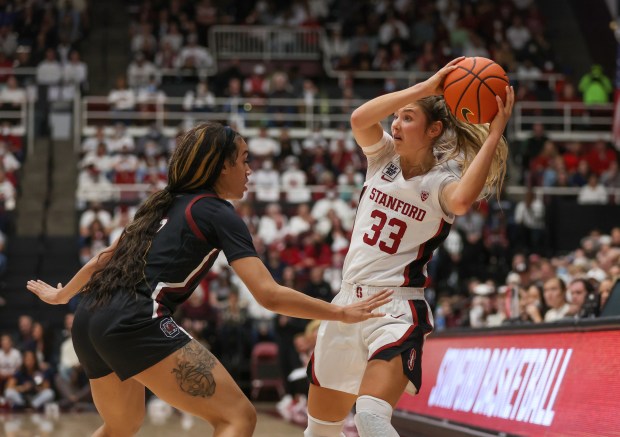 Stanford Cardinal's Hannah Jump (33) looks to pass the ball against South Carolina Gamecocks' Brea Beal (12) in the first half at Stanford Maples Pavilion in Stanford, Calif., on Sunday, Nov. 20, 2022. (Shae Hammond/Bay Area News Group)