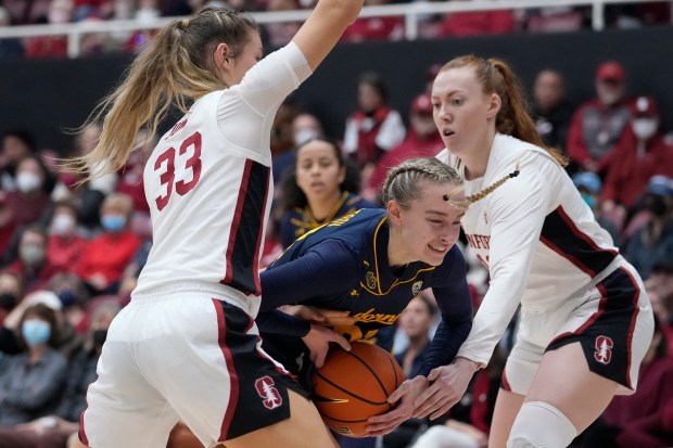 California guard Mia Mastrov, center, tries to get past Stanford guard Hannah Jump, left, and forward Ashten Prechtel, right, during the first half of an NCAA college basketball game in Stanford, Calif., Friday, Dec. 23, 2022. (AP Photo/Godofredo A. Vásquez)