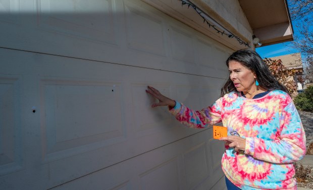 State Sen. Linda Lopez shows bullet holes in her garage door after her home was shot at last month.(Adolphe Pierre-Louis/The Albuquerque Journal/AP)