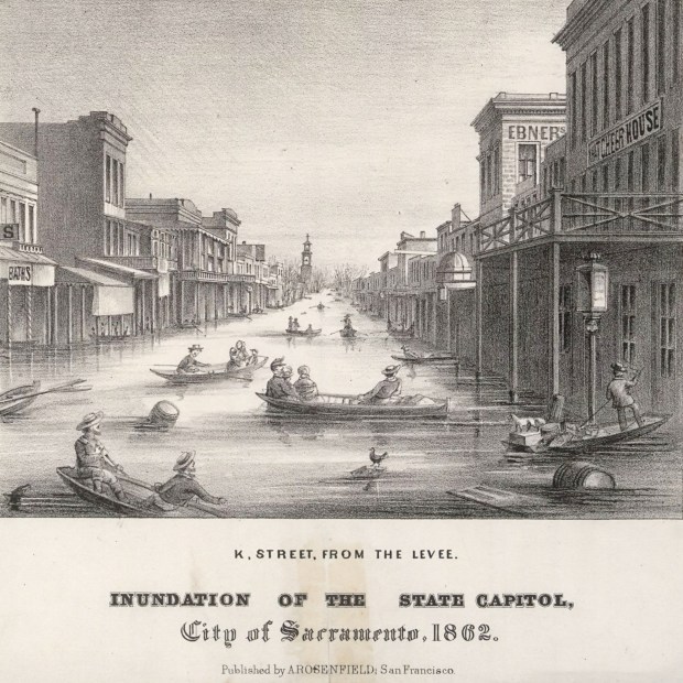 A lithograph shows people in boats on K Street in downtown Sacramento during the Great Flood of 1862. (A. Rosenfield, Wikimedia Commons)
