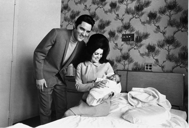 FILE - Lisa Marie Presley poses for her first picture in the lap of her mother, Priscilla, on Feb. 5, 1968, with her father, Elvis Presley. Lisa Marie Presley, singer and only child of Elvis, died on Thursday, Jan. 12, 2023, after a hospitalization, according to her mother, Priscilla. She was 54. (AP Photo/Perry Aycock, File)