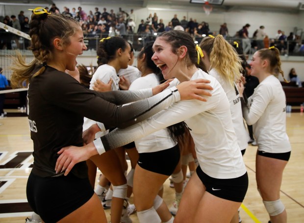 St. Francis' Erin Curtis (6) hugs St. Francis' Whitney Wallace (5) as they celebrate their NorCal Open Division Girls Volleyball Championship 3-1 win against Archbishop Mitty at St. Francis High School in Mountain View on Nov. 15. (Nhat V. Meyer/Staff Photographer)