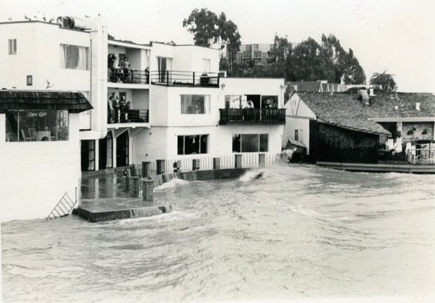 Waves hit a cafe and apartments on the Capitola waterfront during a storm believed by the Capitola Historical Museum to have struck in 1983. By the time a storm hit Capitola Village on Jan. 5, 2023, the cafe site had become Capitola Bar & Grill, several apartments remained as apartments, and some had become Margaritaville. (courtesy of Capitola Historical Museum)