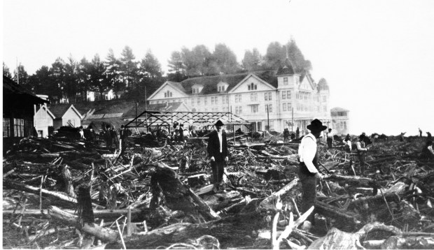 Men clamber through ocean-delivered debris after a storm hit Capitola's waterfront in 1913. Hotel Capitola, in the background, burned to the ground in 1929. (courtesy of Capitola Historical Museum)