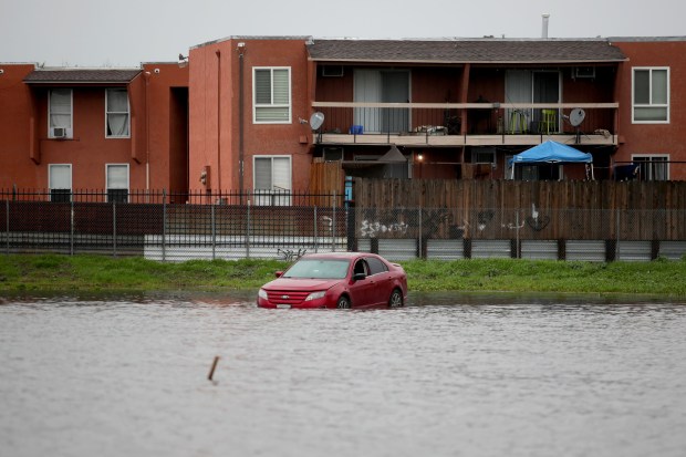 An abandoned car was parked in the parking lot of the flooded Antioch Little League baseball field in Antioch, Calif., as more athospheric river storms hit the bay area on Friday, Jan. 13, 2023. (Ray Chavez/Bay Area News Group)