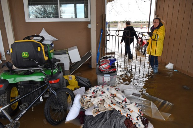 Stephanie Beard, of Brentwood, walks through the backyard of her flooded home on Bixler Road in Brentwood, Calif., on Monday, January 16, 2023. (Jose Carlos Fajardo/Bay Area News Group)