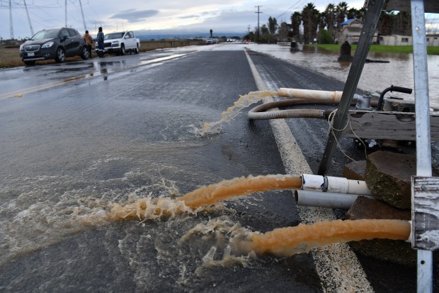Ray Orosco, of Brentwood, uses pumps in an attempt to pump water surrounding his flooded home on Bixler Road in Brentwood, Calif., on Monday, January 16, 2023. (Jose Carlos Fajardo/Bay Area News Group)