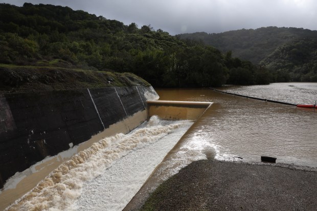 Almaden Reservoir in San Jose, Calif. spills Tuesday, Jan. 10, 2023, after filling to capacity during the latest storms. (Karl Mondon/Bay Area News Group)