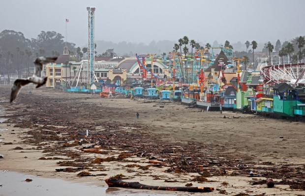 Driftwood and storm detritus wash up in front of the Santa Cruz Beach Boardwalk amusement park on January 11, 2023 in Santa Cruz, California. (Photo by Mario Tama/Getty Images)