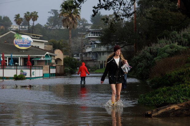 Lisa Bailey of Capitola wades through ankle deep water in Aptos, Calif., on Jan. 5, 2023. (Dai Sugano/Bay Area News Group)