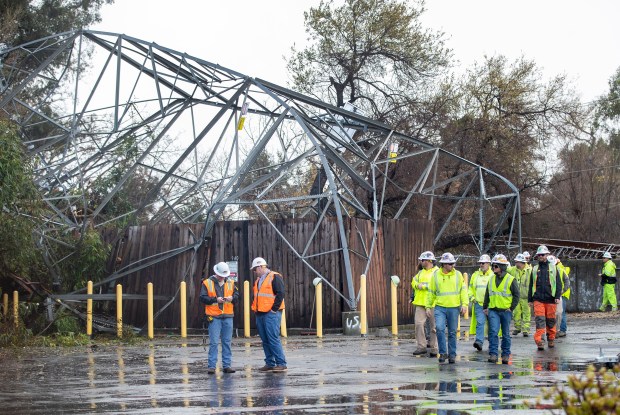 Utility workers assess a transmission tower that collapsed in Willow Glen in San Jose, Calif., Tuesday, Jan. 10, 2023. (Karl Mondon/Bay Area News Group)