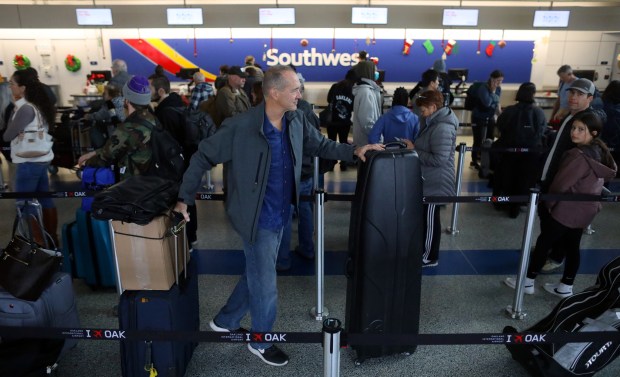 OAKLAND, CALIFORNIA - DECEMBER 27: Travelers wait in line at the Southwest Airlines check-in counter in Terminal 2 of the Oakland International Airport on Tuesday, Dec. 27, 2022, in Oakland, Calif. (Aric Crabb/Bay Area News Group)