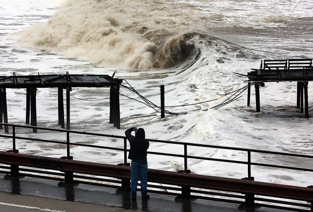 Powerful waves continue to batter the Capitola Wharf Thursday morning after the storm destroyed a section of the structure. (Shmuel Thaler - Santa Cruz Sentinel)