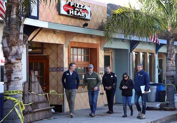 California Gov. Gavin Newsom tours the storm-damaged Capitola Esplanade on Tuesday with, from left, City Manager Jamie Goldstein, Police Chief Andrew Dally, Capitola Mayor Margaux Kaiser and state Natural Resources Secretary Wade Crowfoot. (Shmuel Thaler -- Santa Cruz Sentinel)