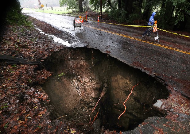 The storm formed a large sinkhole Wednesday on Glenwood Drive above Scotts Valley. (Shmuel Thaler - Santa Cruz Sentinel)