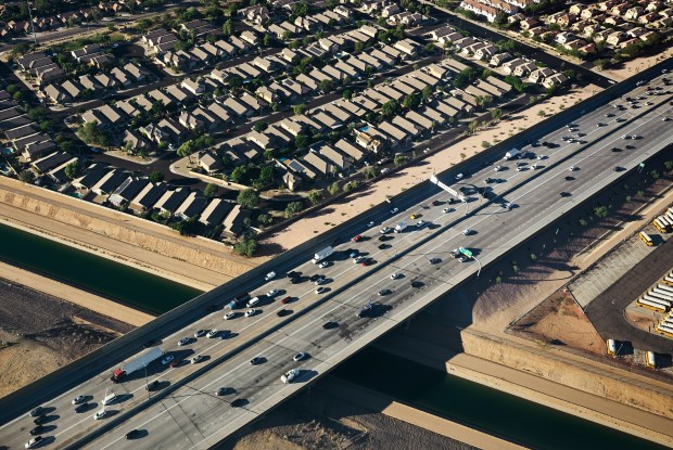 Morning traffic traveling Arizona State Route 101 crosses the Central Arizona Project on Oct. 25, 2022, outside Phoenix, Arizona. The flight for aerial photography was provided by LightHawk.(Photo by RJ Sangosti/The Denver Post)