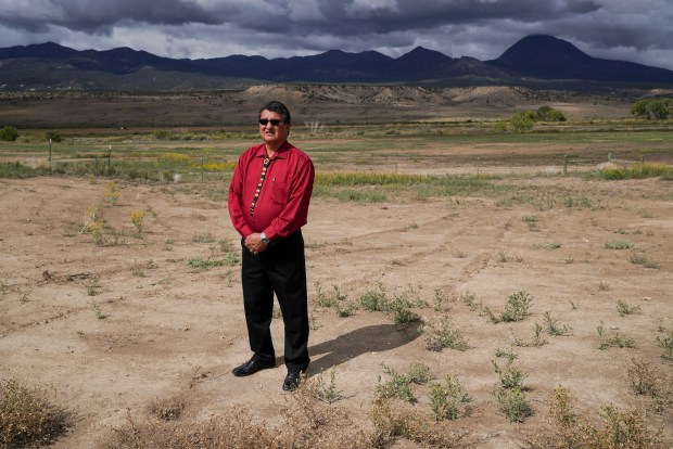 Ute Mountain Ute Chairman Manuel Heart stands on land in the Ute Mountain Ute Reservation as clouds hover over the Ute Mountains behind him in Towaoc, Colorado on Oct. 1, 2021. (Photo by Rebecca Slezak/The Denver Post)